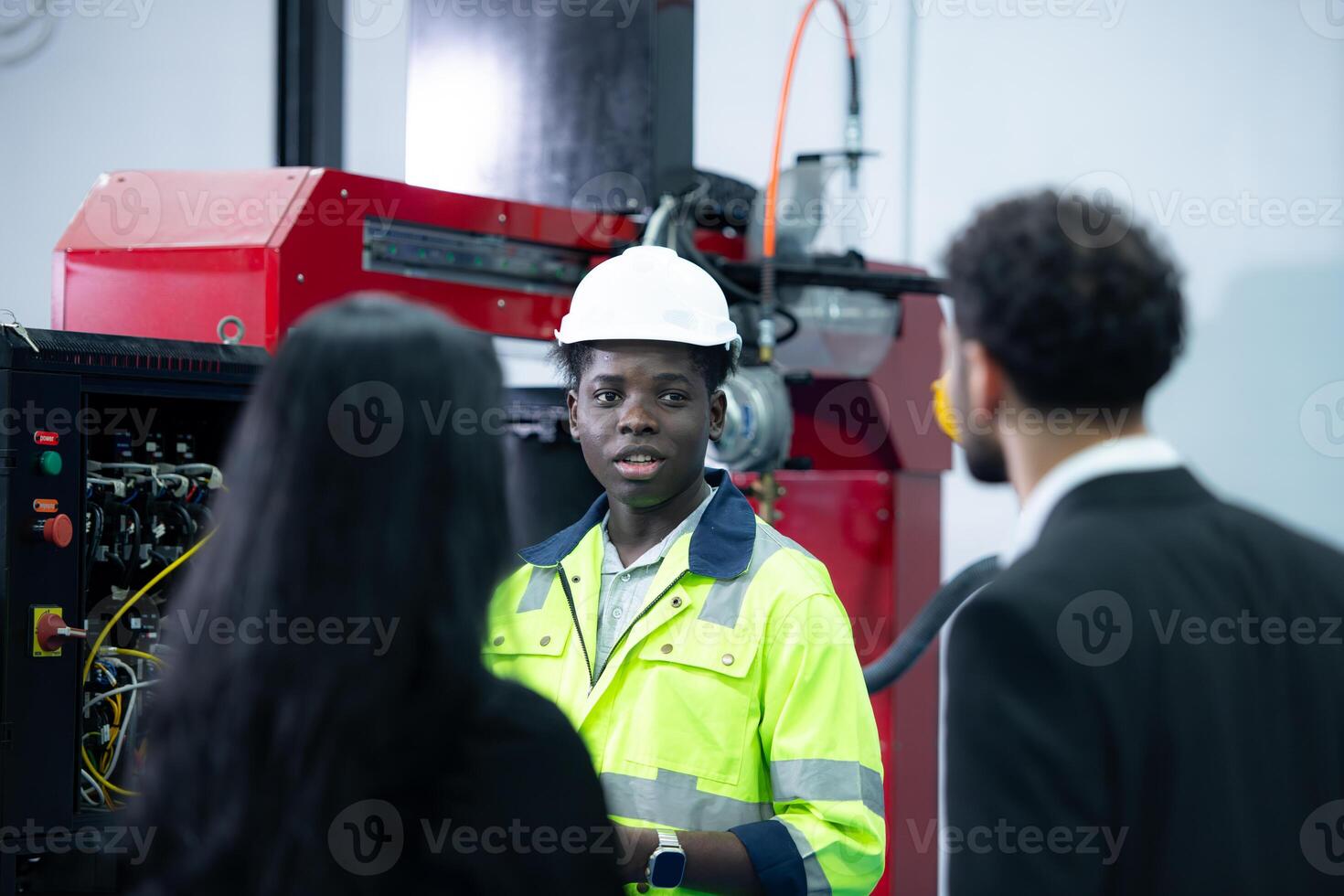 Technicians are introducing industrial hand robots to businessperson of factory industry who will use them in large-scale complex manufacturing operations. photo