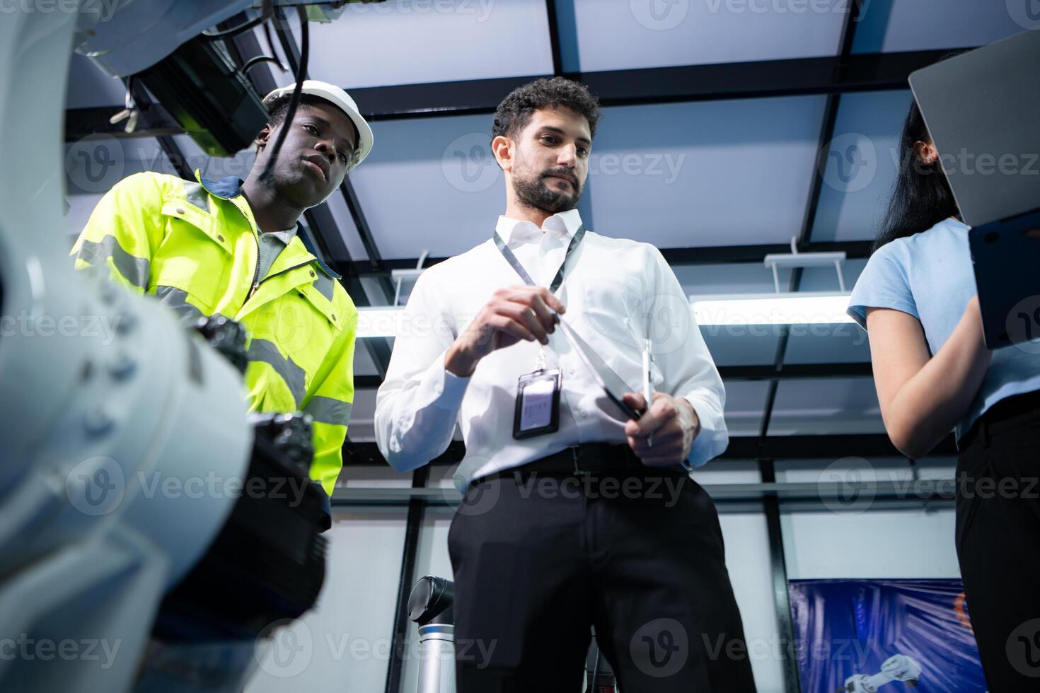 Technicians are introducing industrial hand robots to businessperson of factory industry who will use them in large-scale complex manufacturing operations. photo