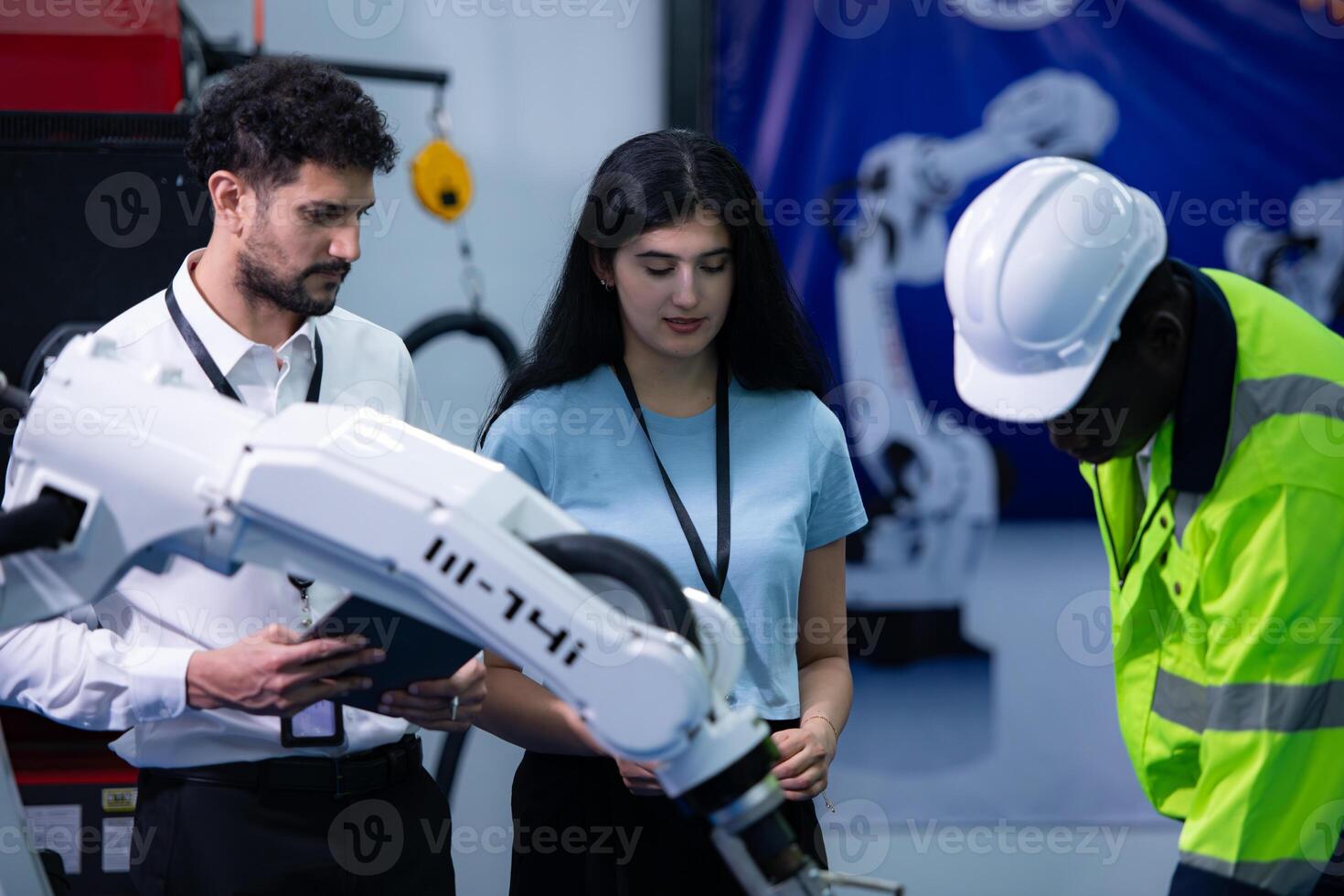 Technicians are introducing industrial hand robots to businessperson of factory industry who will use them in large-scale complex manufacturing operations. photo