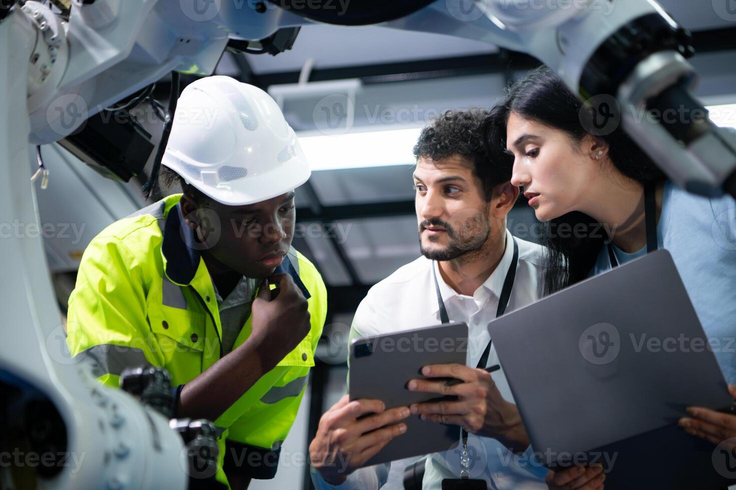 Technicians are introducing industrial hand robots to businessperson of factory industry who will use them in large-scale complex manufacturing operations. photo