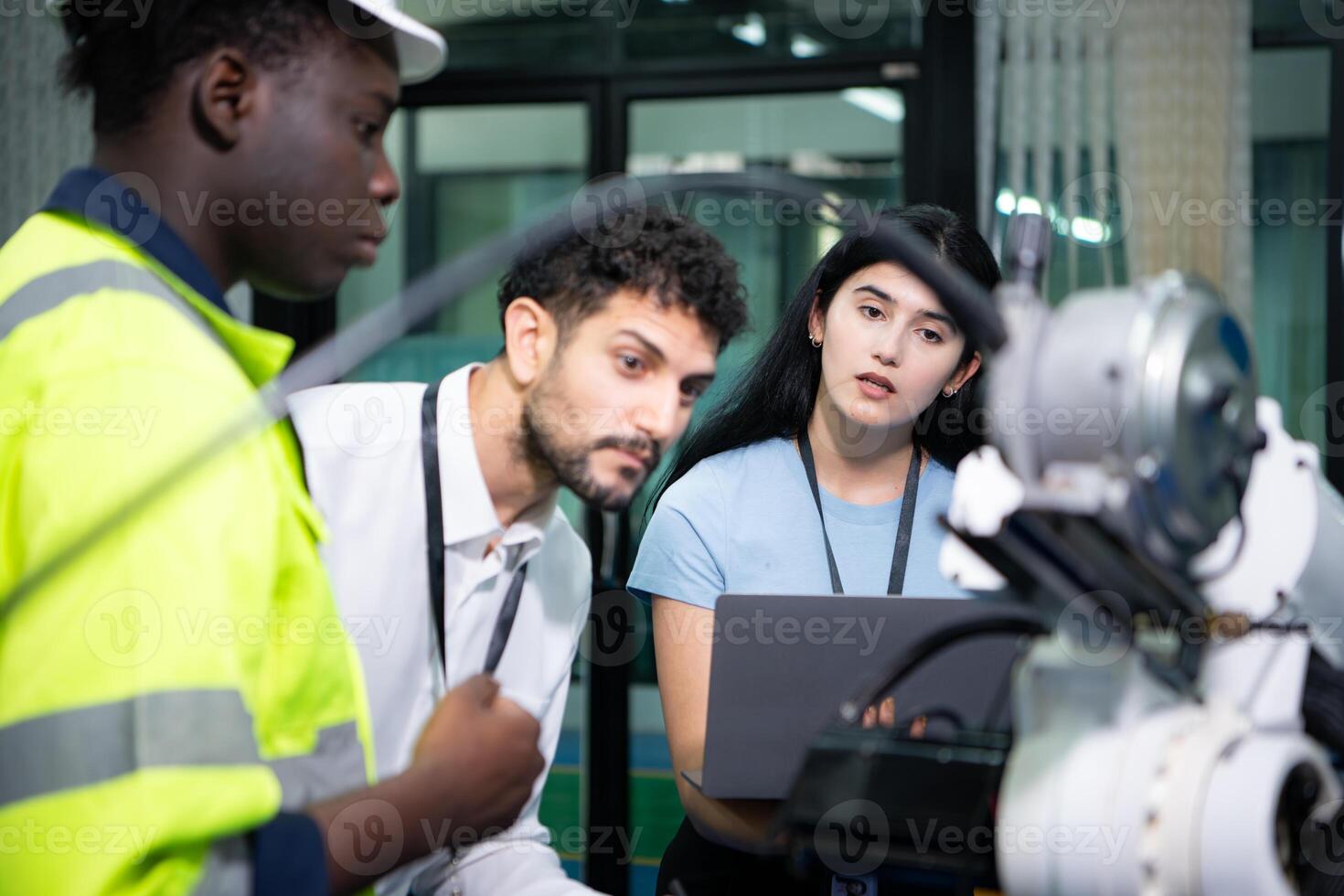 Technicians are introducing industrial hand robots to businessperson of factory industry who will use them in large-scale complex manufacturing operations. photo
