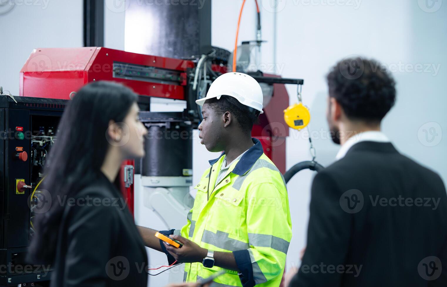 Technicians are introducing industrial hand robots to businessperson of factory industry who will use them in large-scale complex manufacturing operations. photo