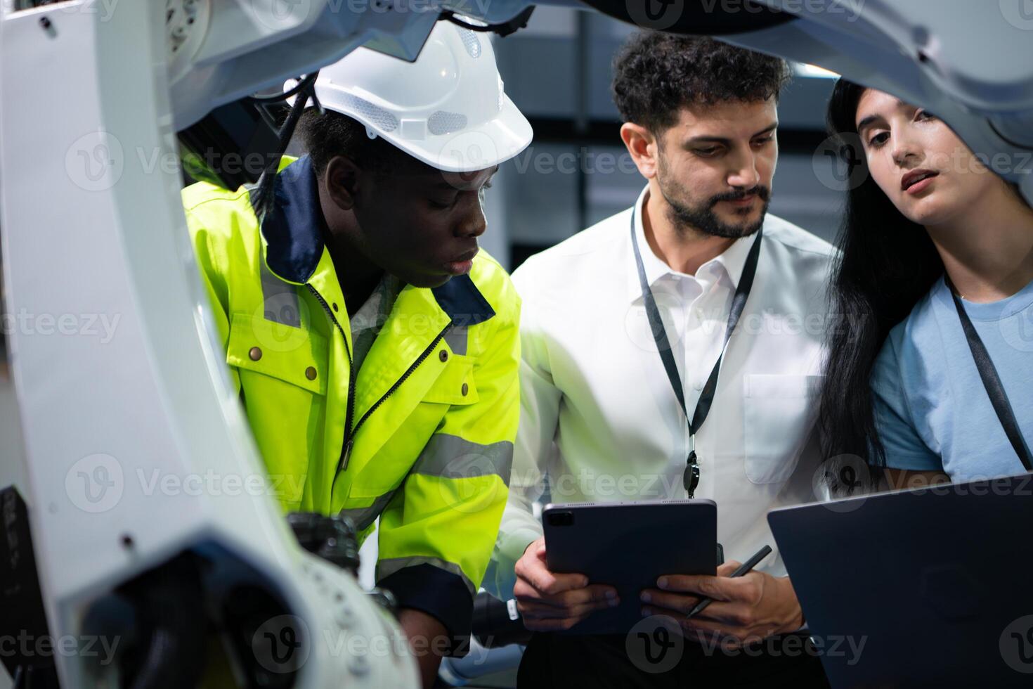 Technicians are introducing industrial hand robots to businessperson of factory industry who will use them in large-scale complex manufacturing operations. photo