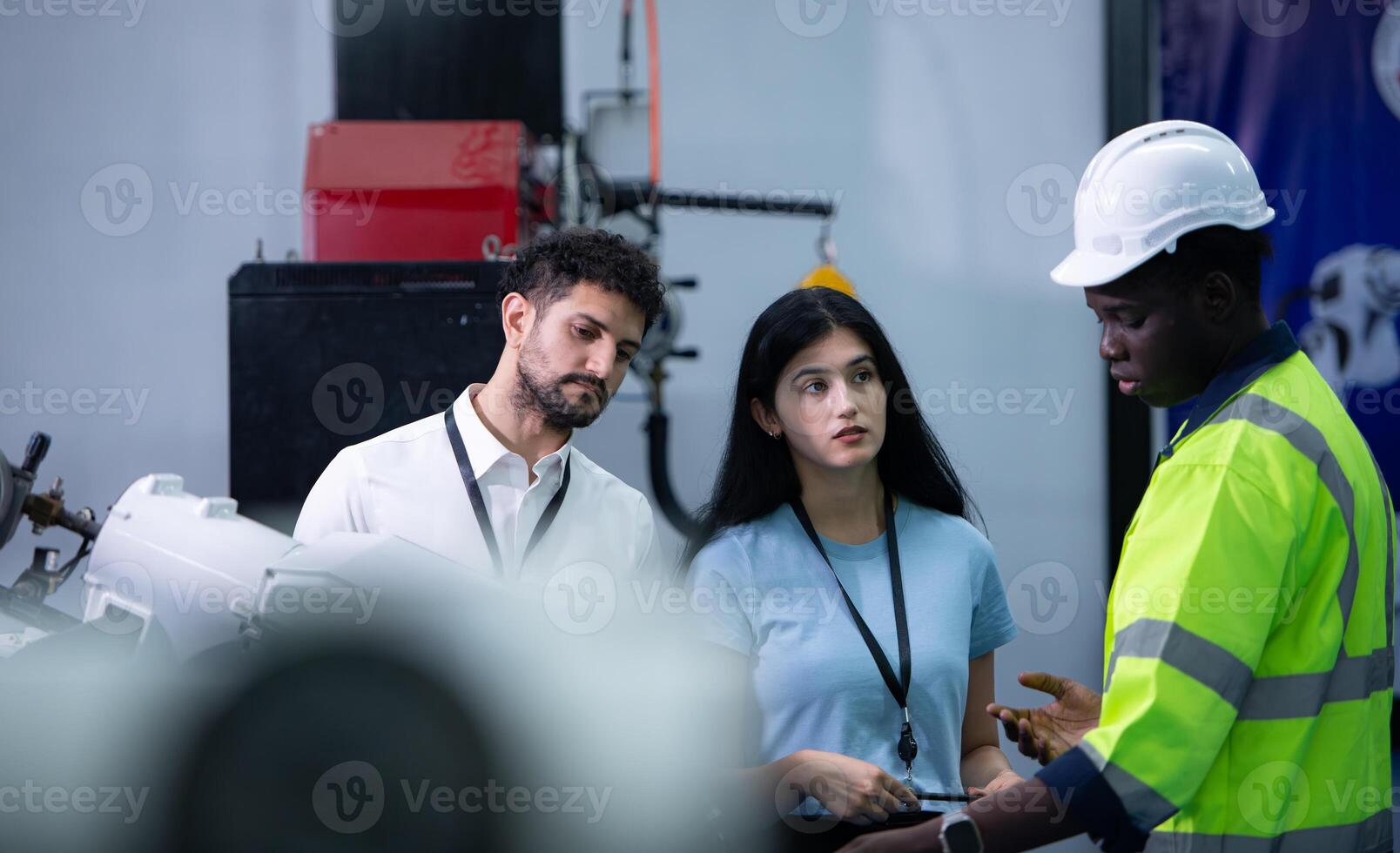 Technicians are introducing industrial hand robots to businessperson of factory industry who will use them in large-scale complex manufacturing operations. photo