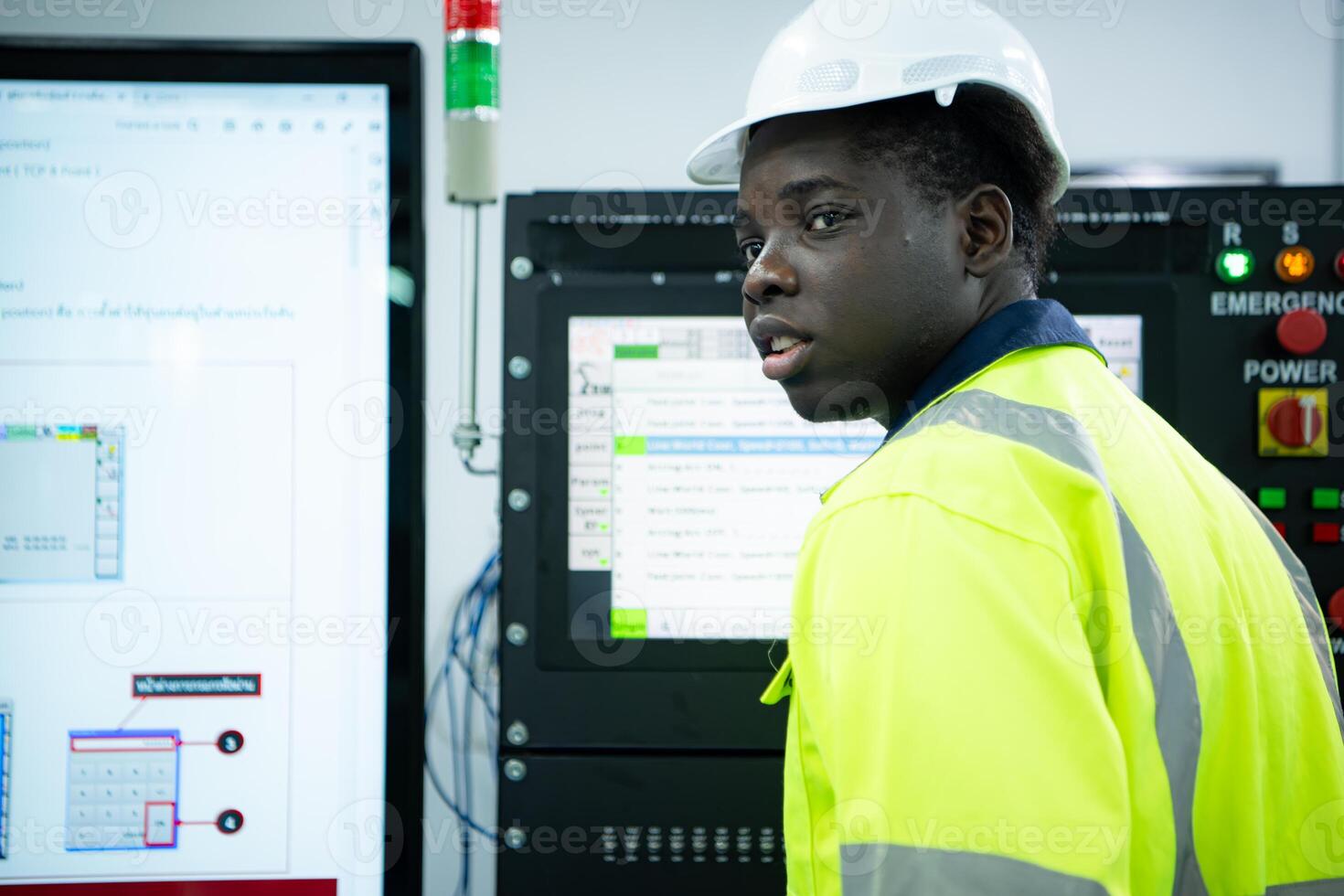 Portrait of African-American male engineer working on computer control in factory photo