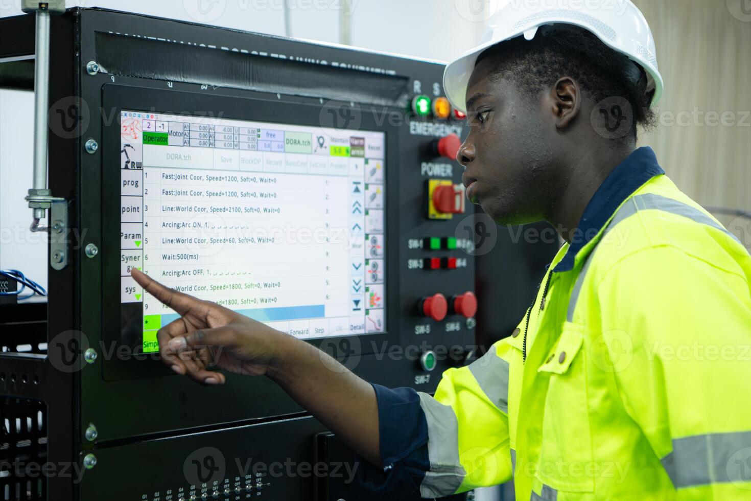 Portrait of African-American male engineer working on computer control in factory photo