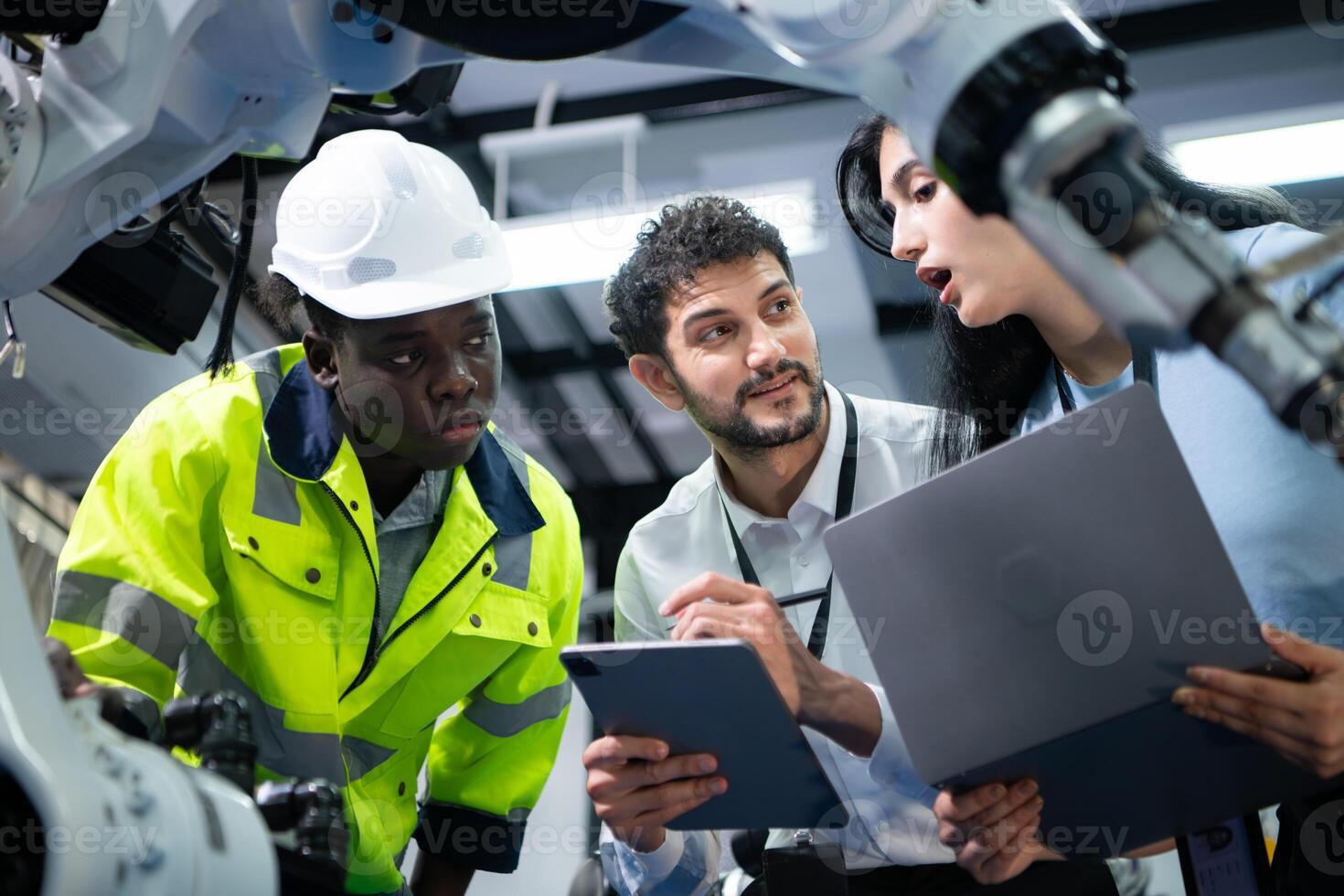 Technicians are introducing industrial hand robots to businessperson of factory industry who will use them in large-scale complex manufacturing operations. photo