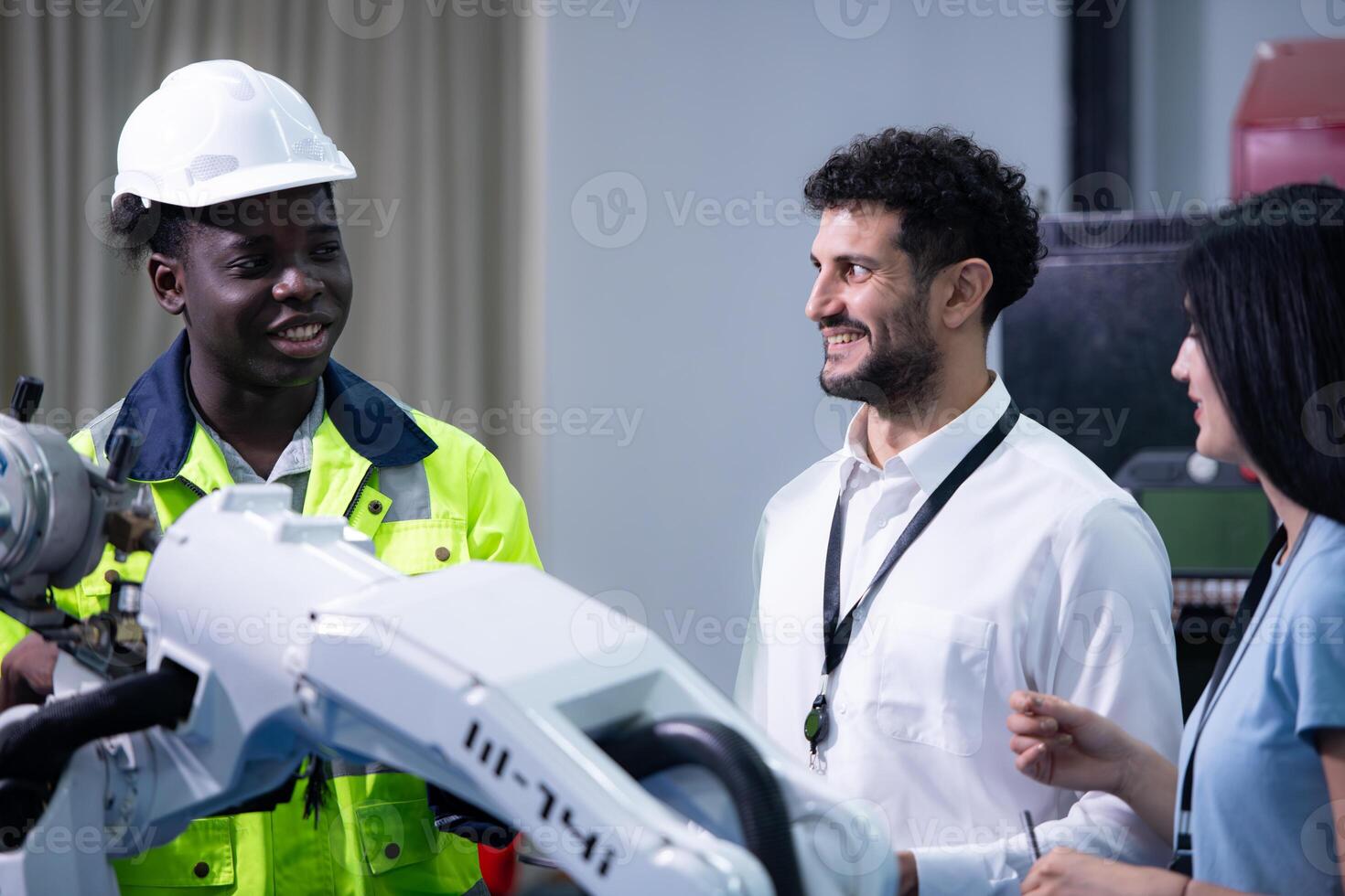 Technicians are introducing industrial hand robots to businessperson of factory industry who will use them in large-scale complex manufacturing operations. photo
