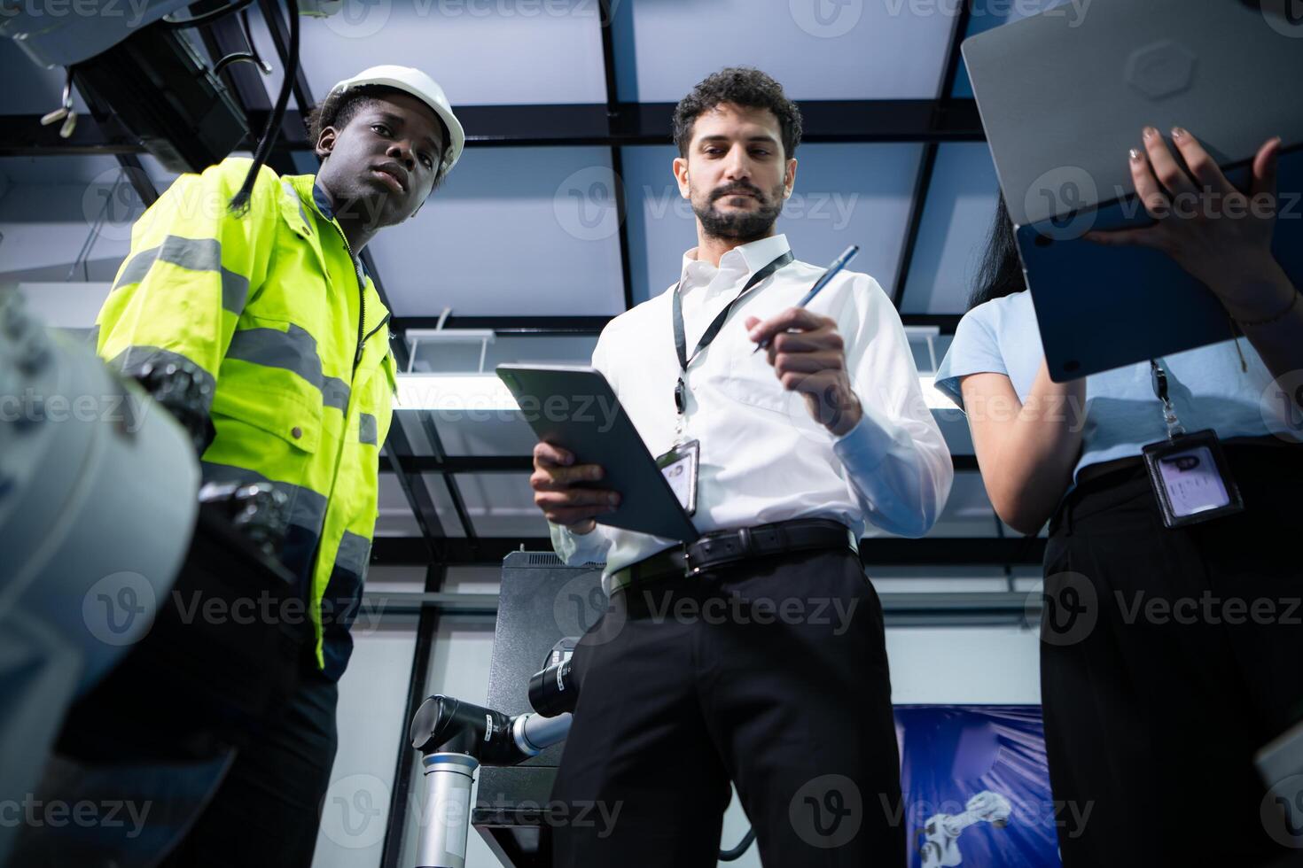 Technicians are introducing industrial hand robots to businessperson of factory industry who will use them in large-scale complex manufacturing operations. photo