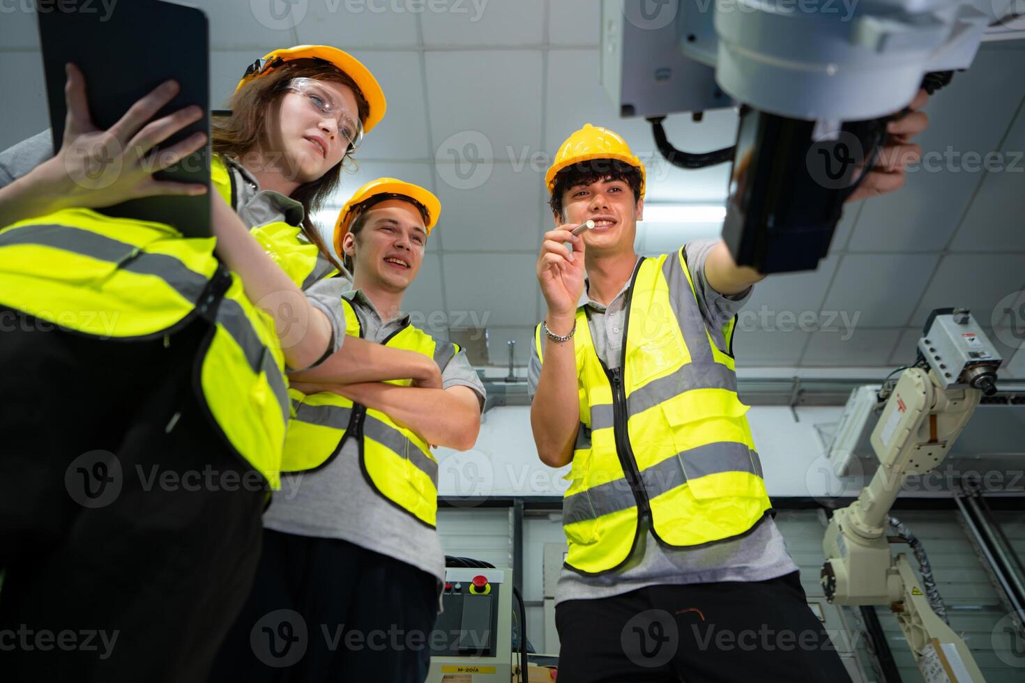 Engineer and technician discussing the robotic arm in factory about work operating, maintenance and repair photo