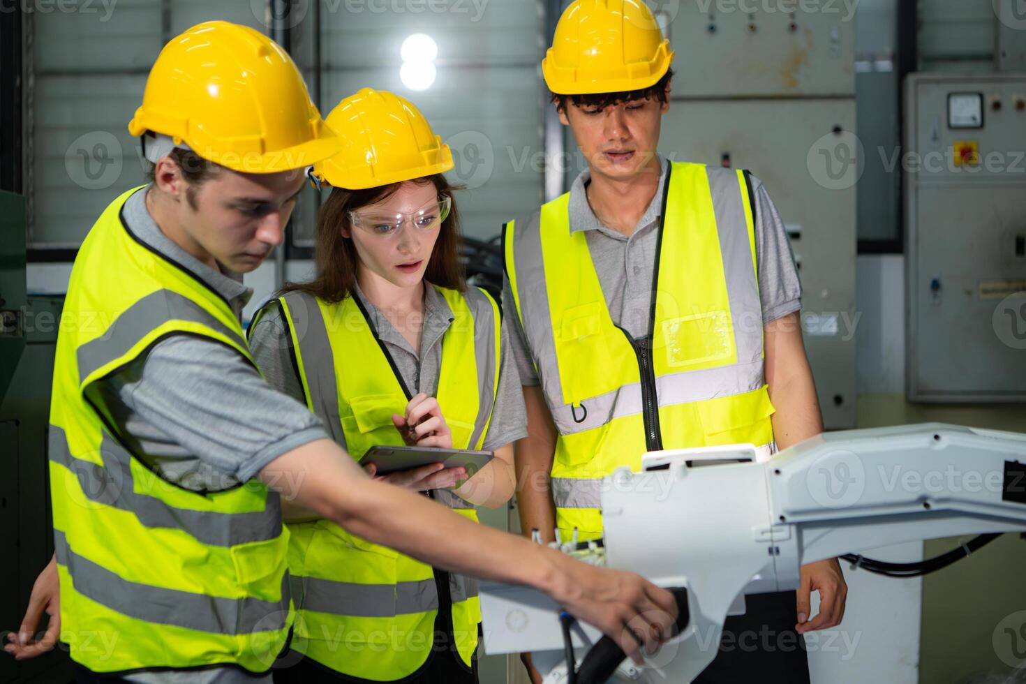Engineer and technician discussing the robotic arm in factory about work operating, maintenance and repair photo