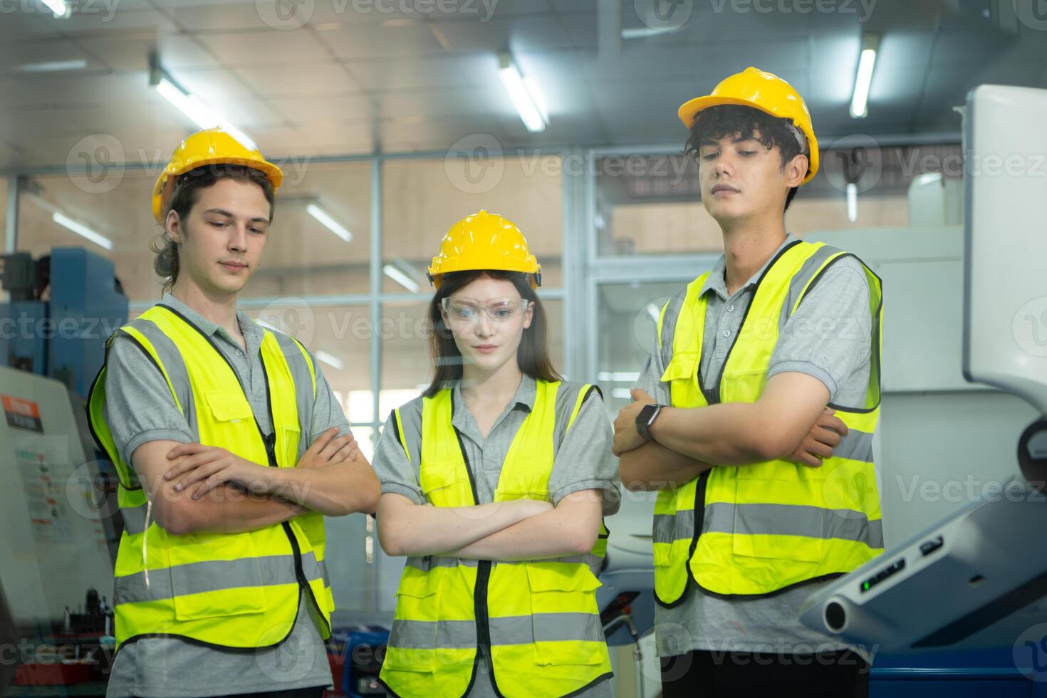 Group of factory workers greeting each other with joint hands together in warehouse photo