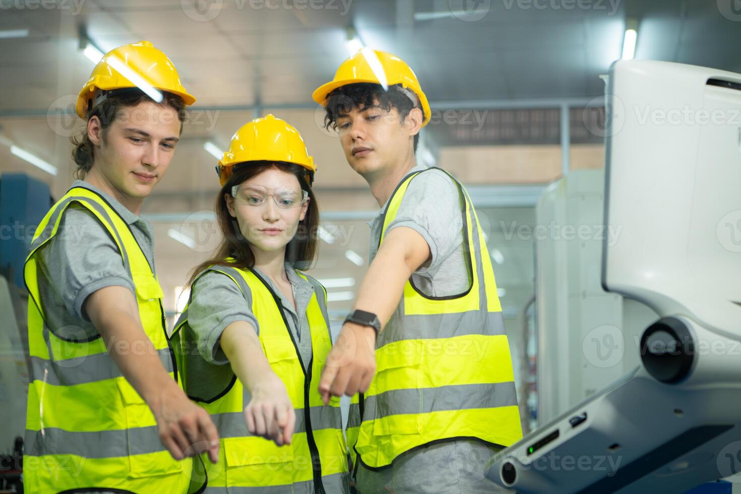 Group of factory workers greeting each other with joint hands together in warehouse photo