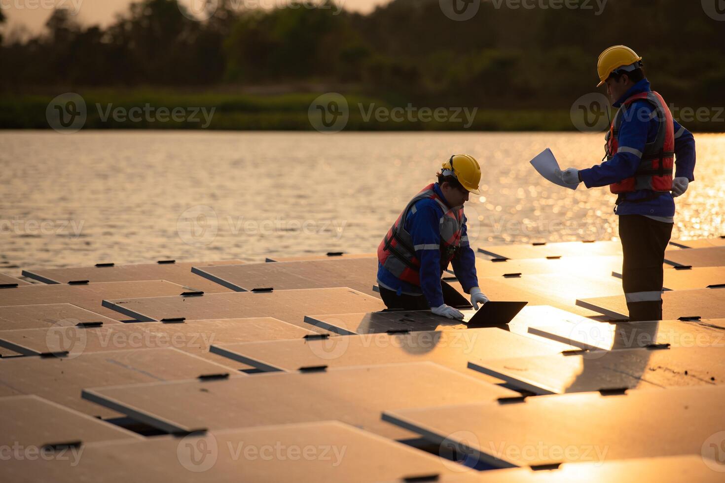 Photovoltaic engineers work on floating photovoltaics. Inspect and repair the solar panel equipment floating on the water. photo