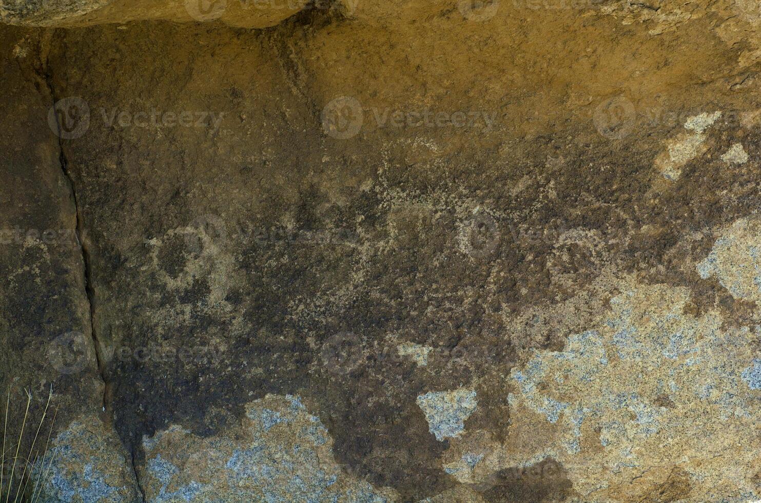 Ancient figures on the the stone photo