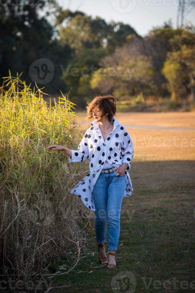 Fashion shot of a beautiful boho style girl on nature background. Boho, hippie. photo