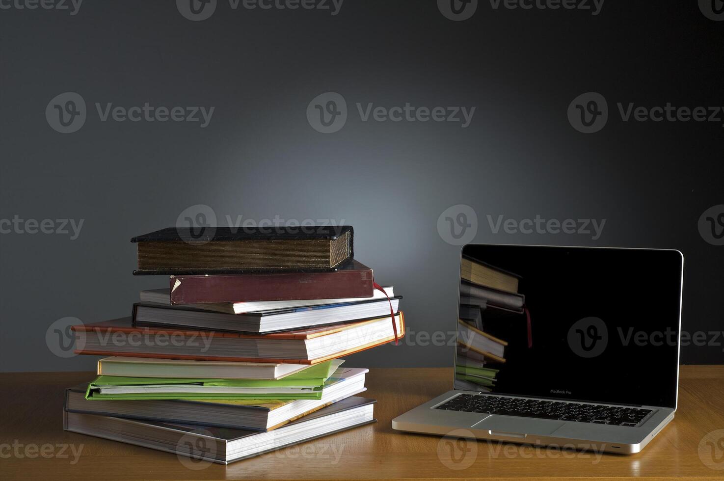 Stack of book and laptop photo