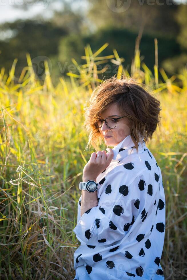 Fashion shot of a beautiful boho style girl on nature background. Boho, hippie. photo
