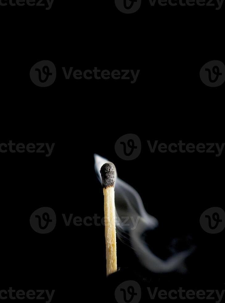Wooden match burning on a black background photo