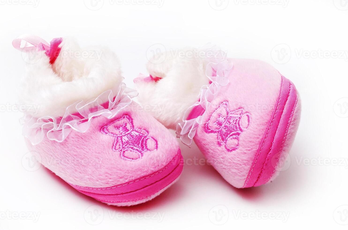 Pair of baby's slippers hanging on a rope. Including copy space photo
