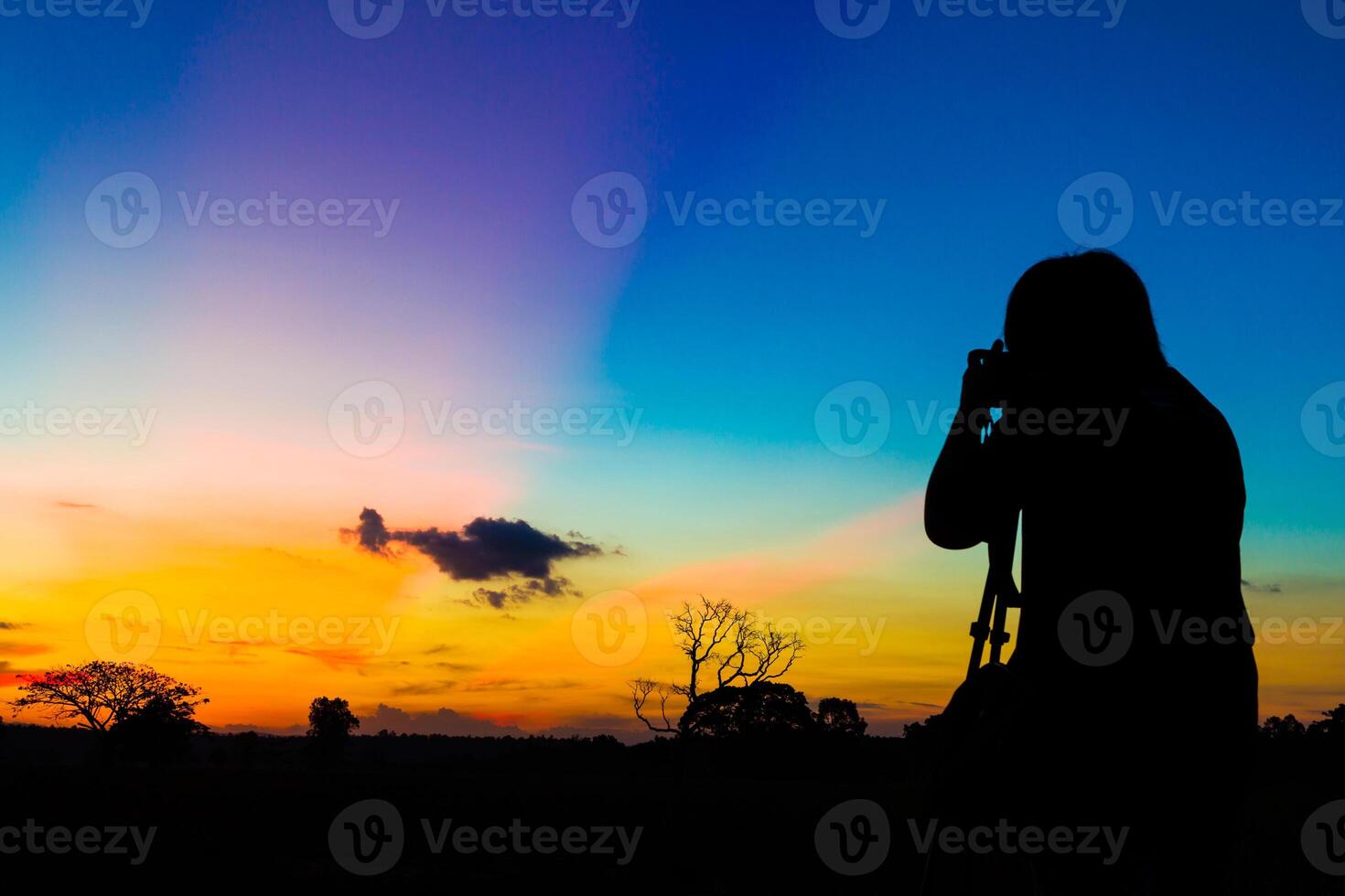 Silhouette photographer with sunset photo