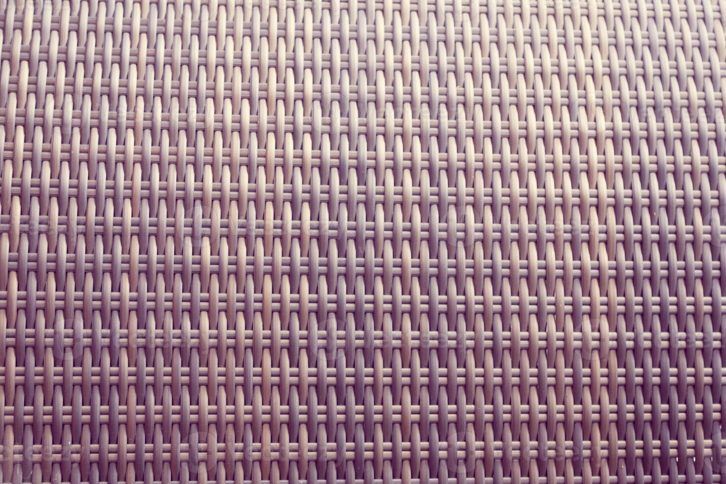 Synthetic rattan texture weaving background as used on outdoor garden furniture. photo