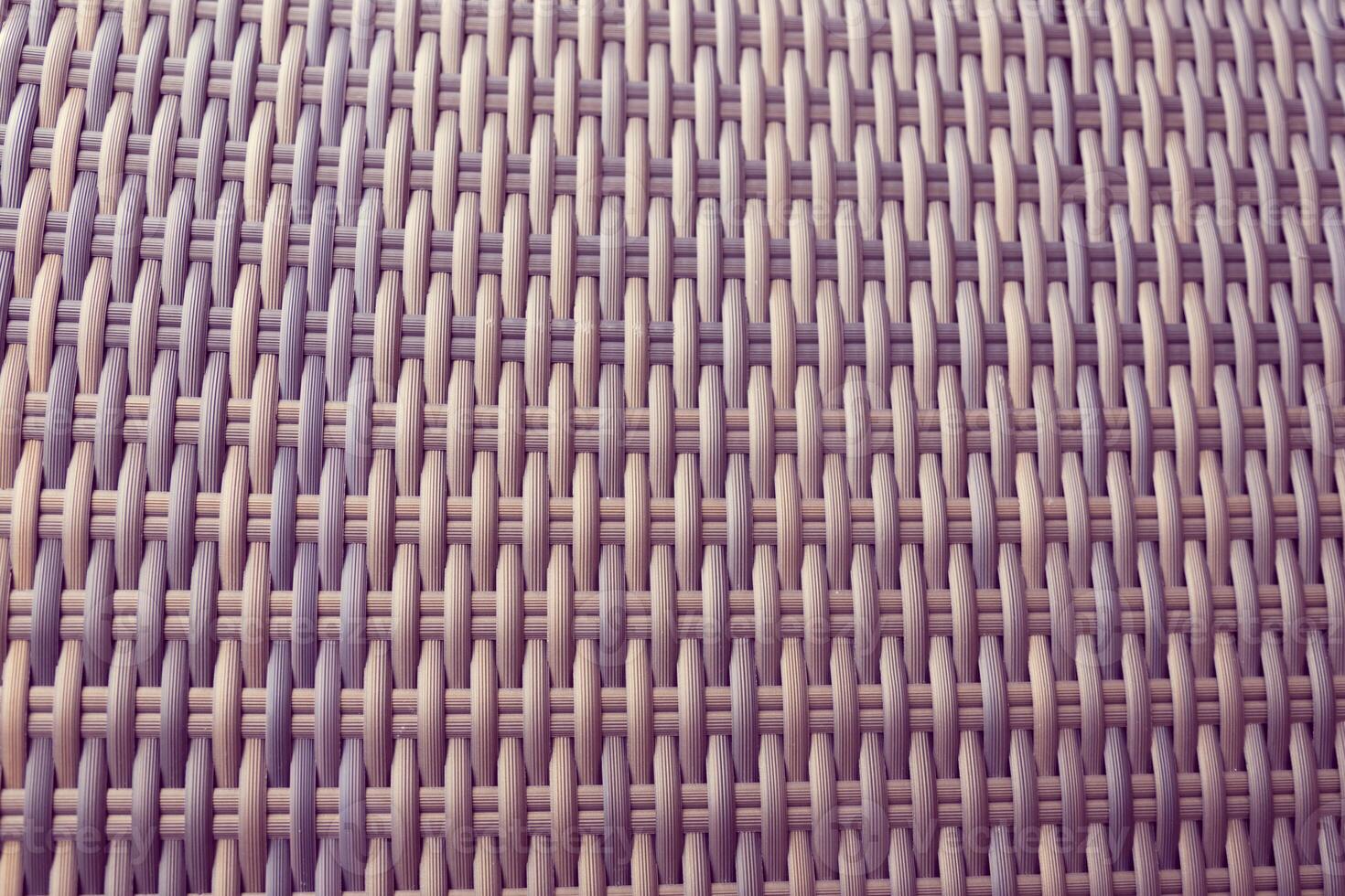 Synthetic rattan texture weaving background as used on outdoor garden furniture. photo
