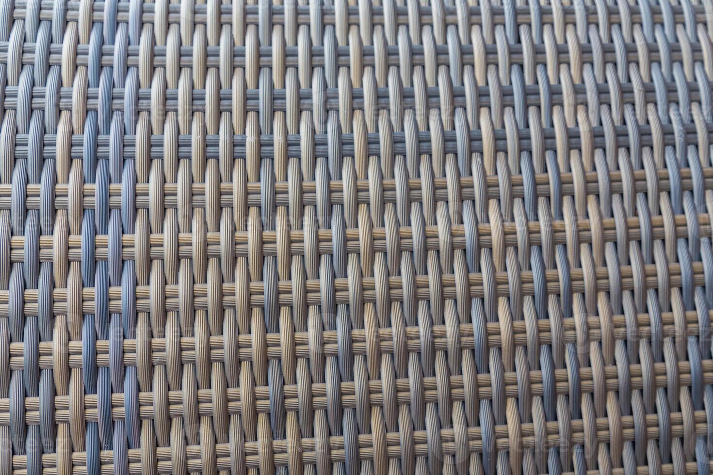 Synthetic rattan texture weaving background as used on outdoor garden furniture. photo