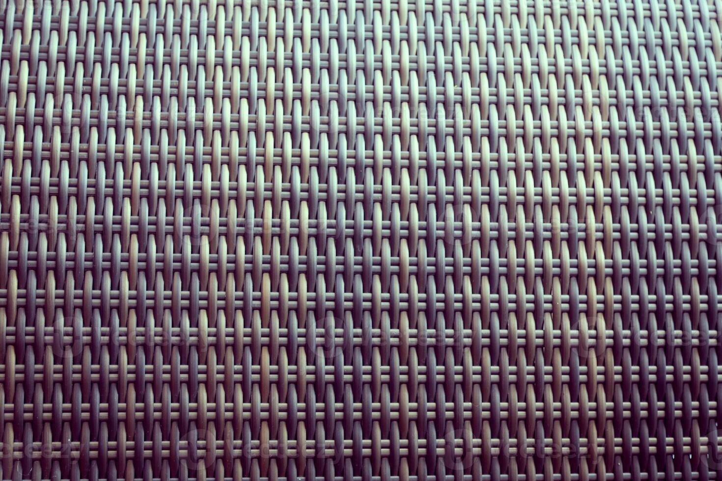 Synthetic rattan texture weaving background as used on outdoor garden furniture. photo