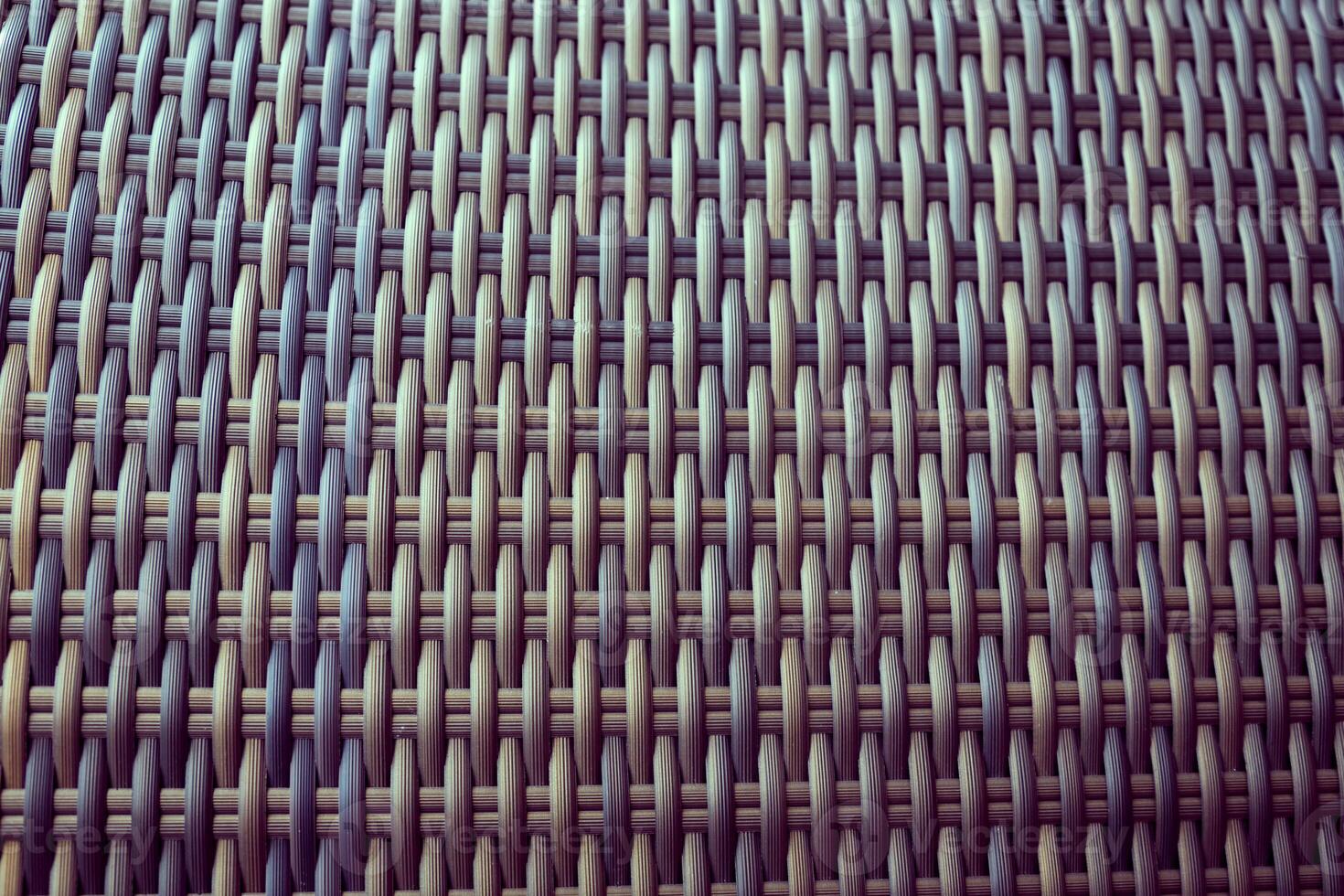 Synthetic rattan texture weaving background as used on outdoor garden furniture. photo