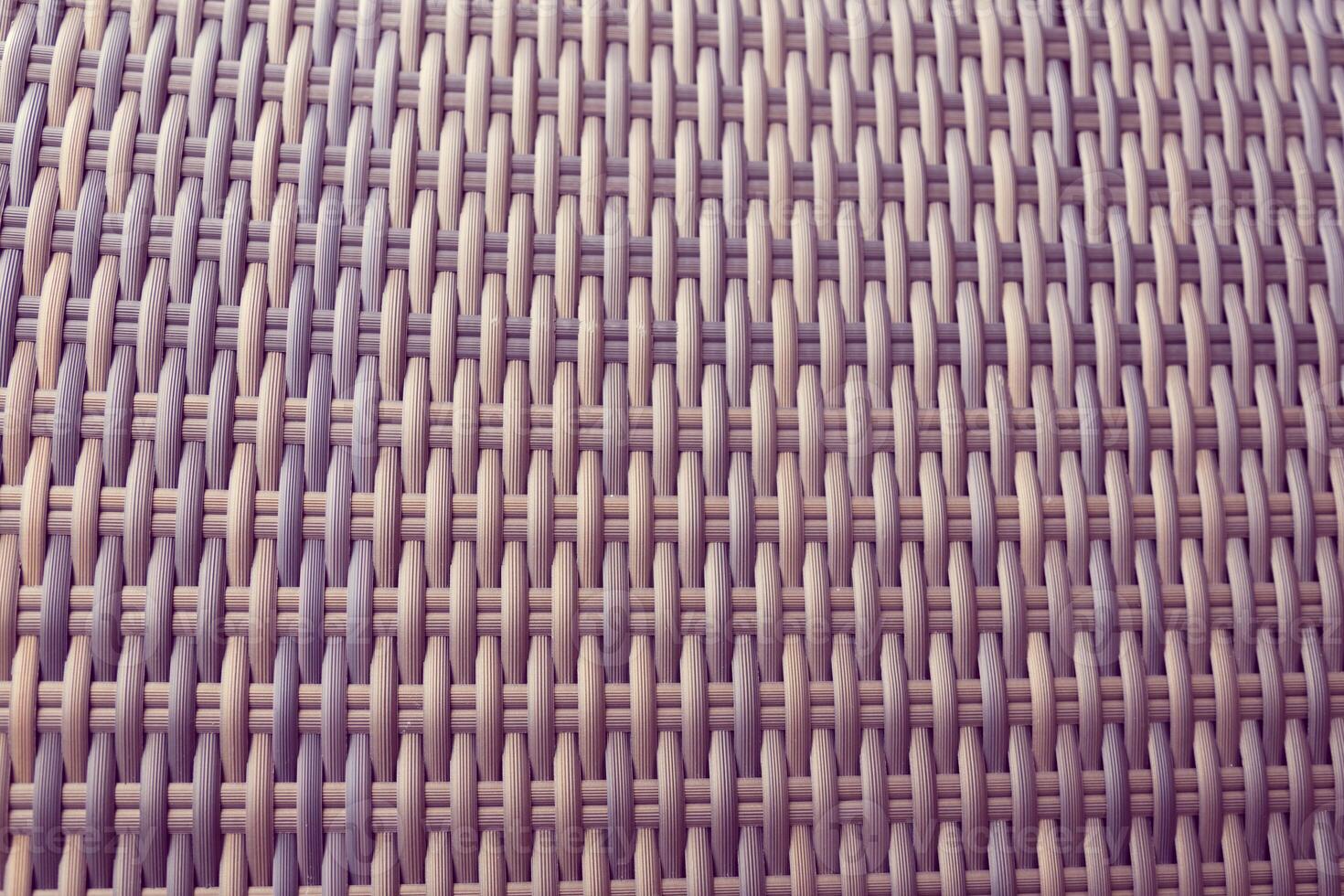 Synthetic rattan texture weaving background as used on outdoor photo