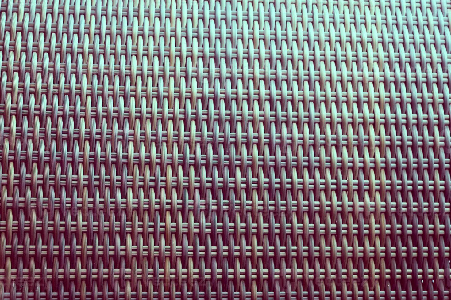 Synthetic rattan texture weaving background as used on outdoor garden furniture. photo