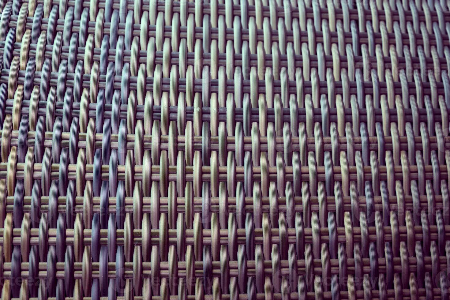 Synthetic rattan texture weaving background as used on outdoor photo