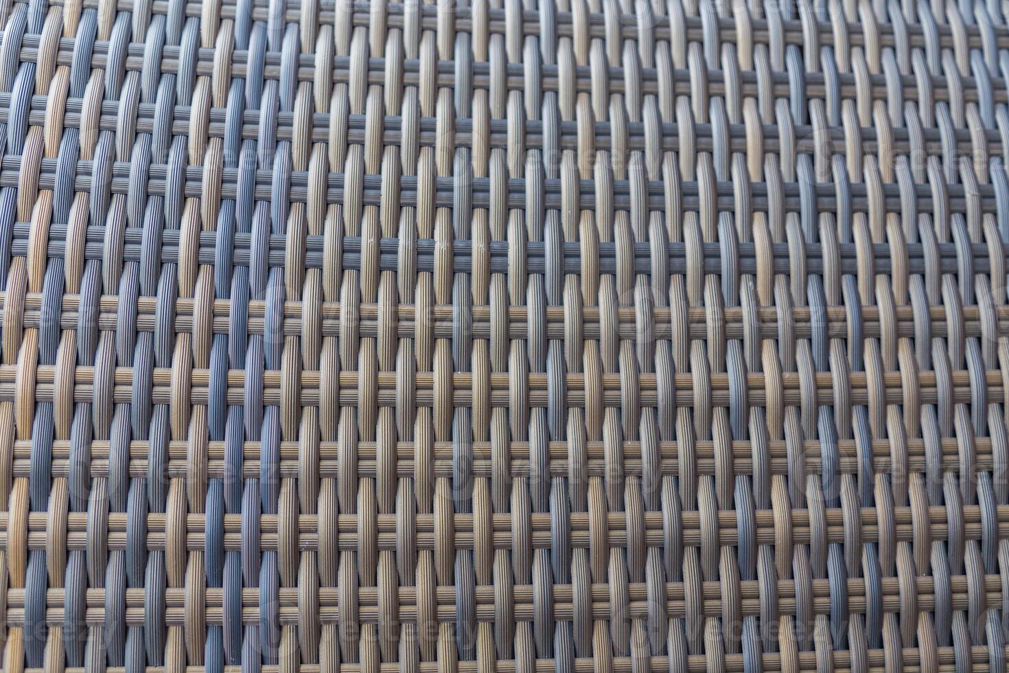 Synthetic rattan texture weaving background as used on outdoor photo