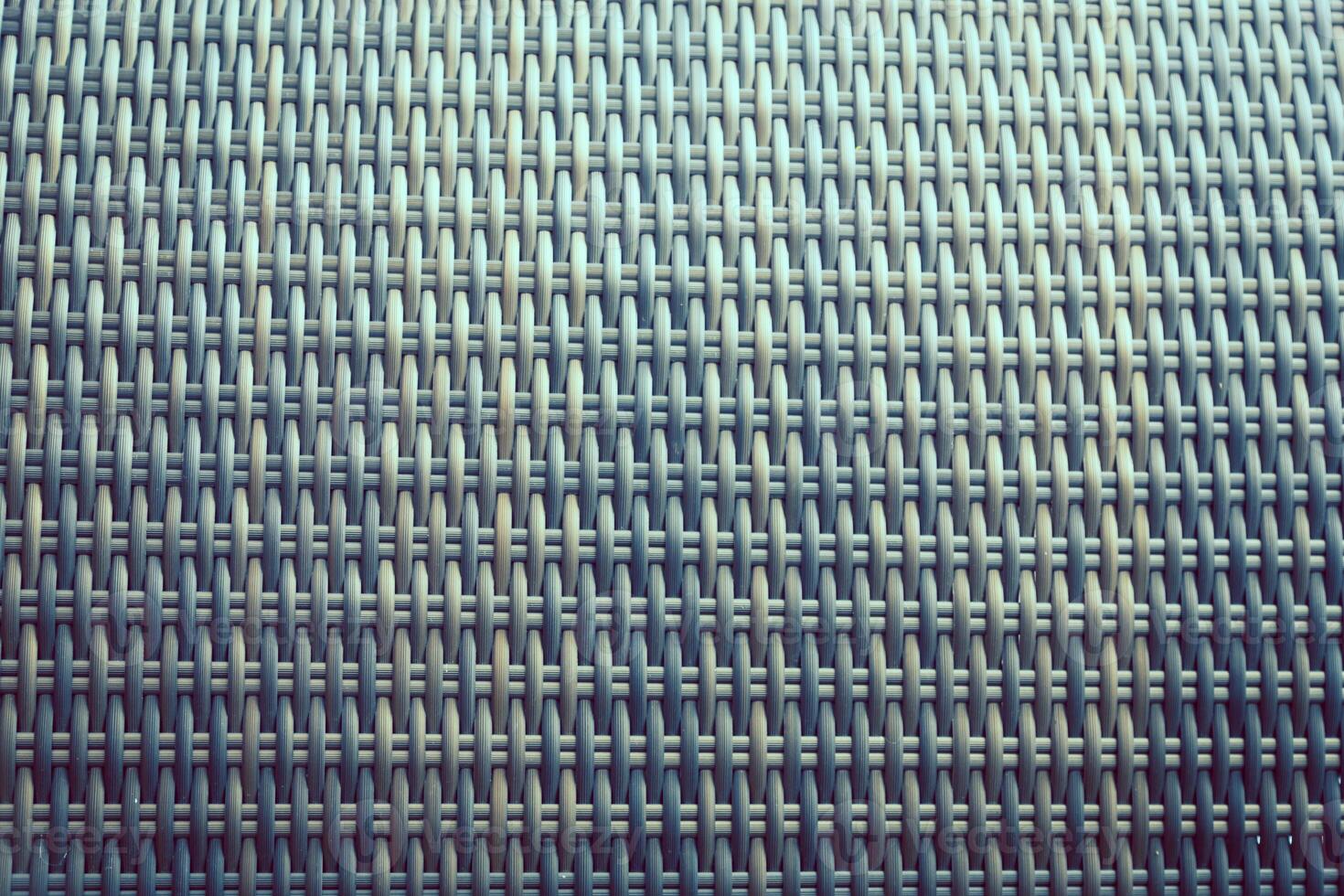 Synthetic rattan texture weaving background as used on outdoor garden furniture. photo