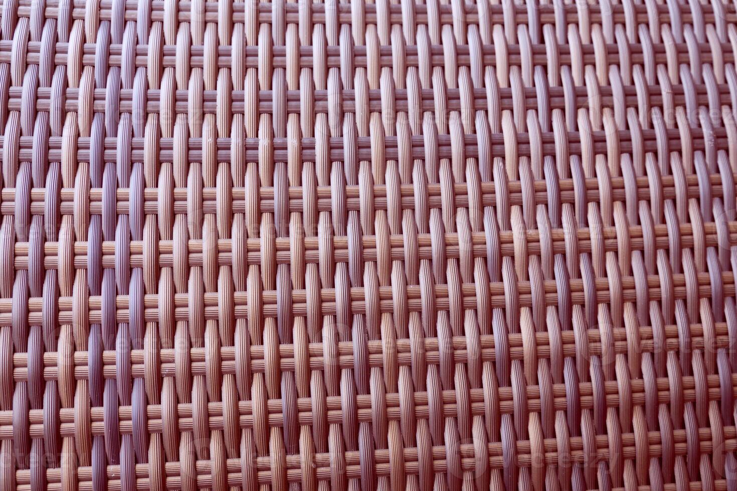 Synthetic rattan texture weaving background as used on outdoor garden furniture. photo