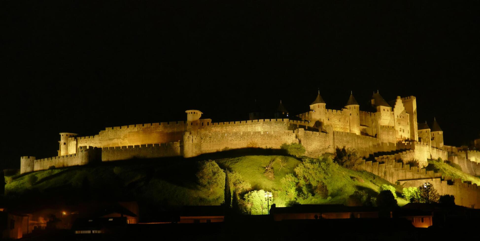 Night lights on the ramparts and castle towers of medieval Carcassonne photo