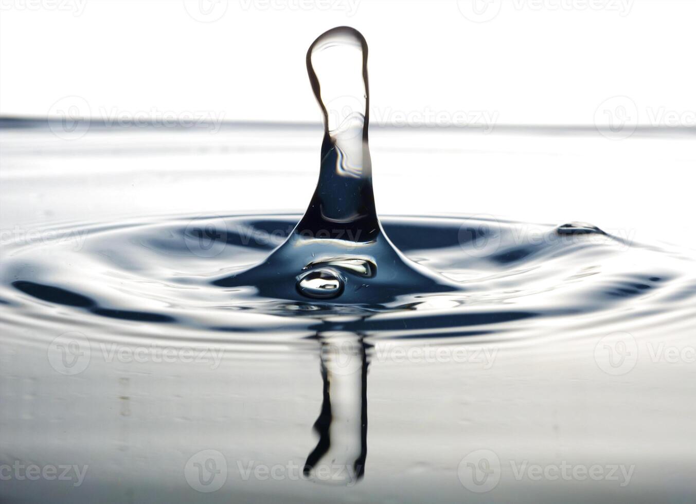 The round transparent drop of water, falls downwards photo