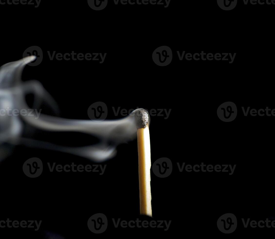 Wooden match burning on a black background photo