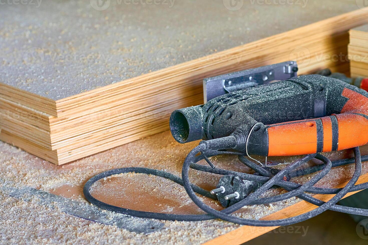 Heating industrial dryer gun tool, wood plywood sheets and sawdust photo