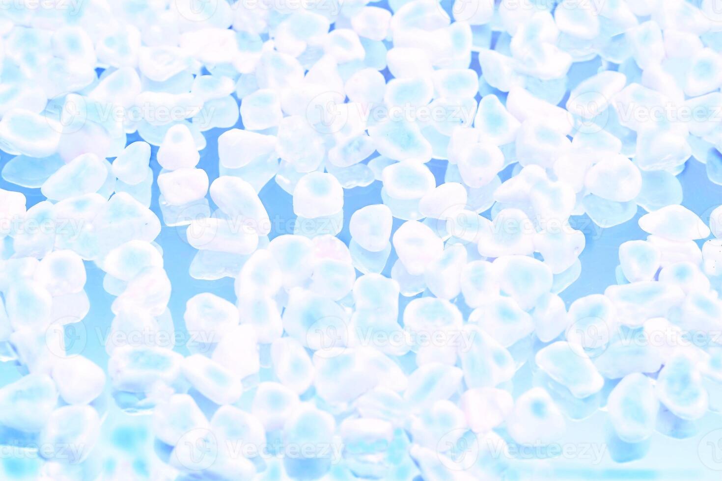 Transparent white stones on blue.Molecular cold temperature photo