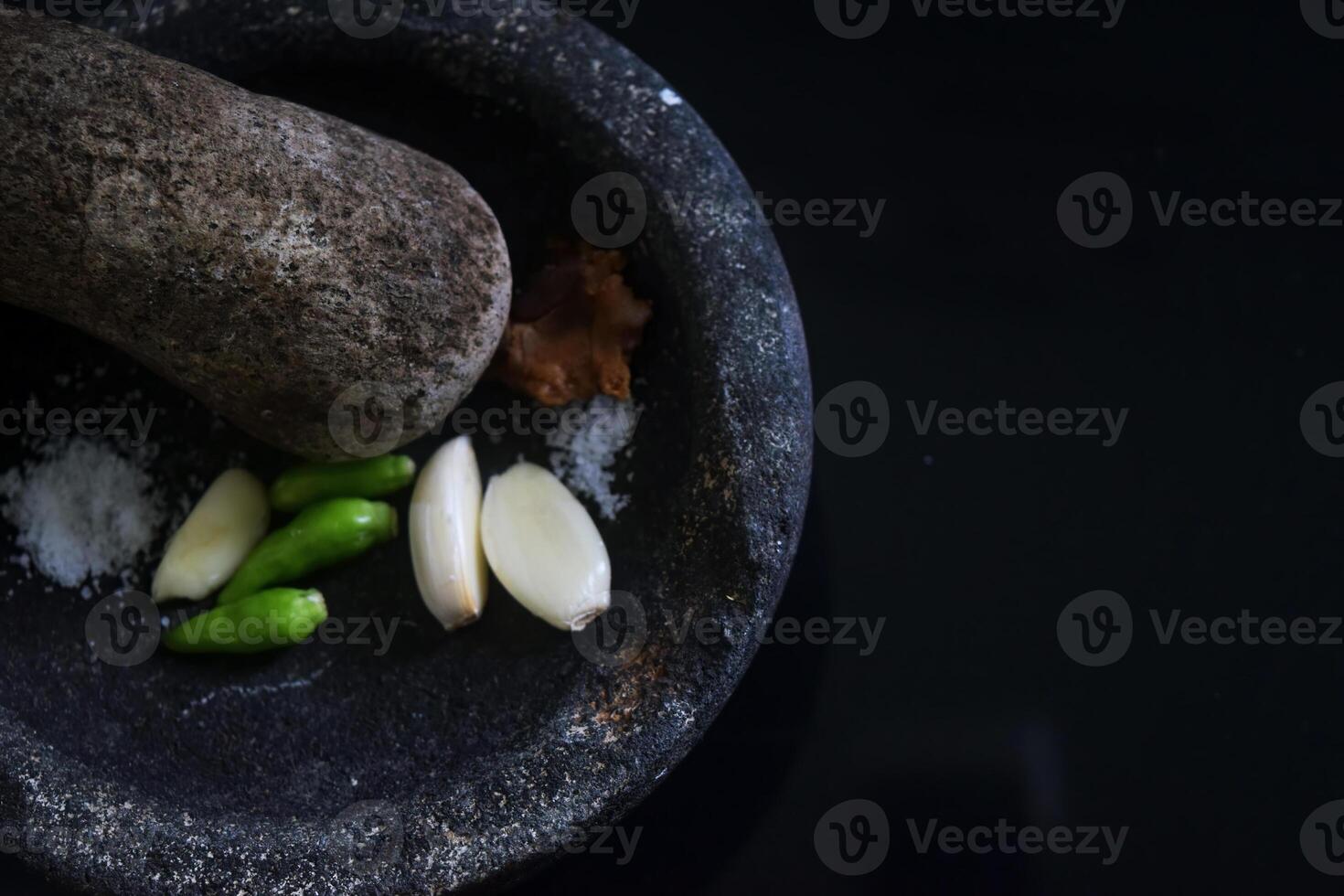 Close up of a kitchen tool in the form of a stone blender called Cobek photo