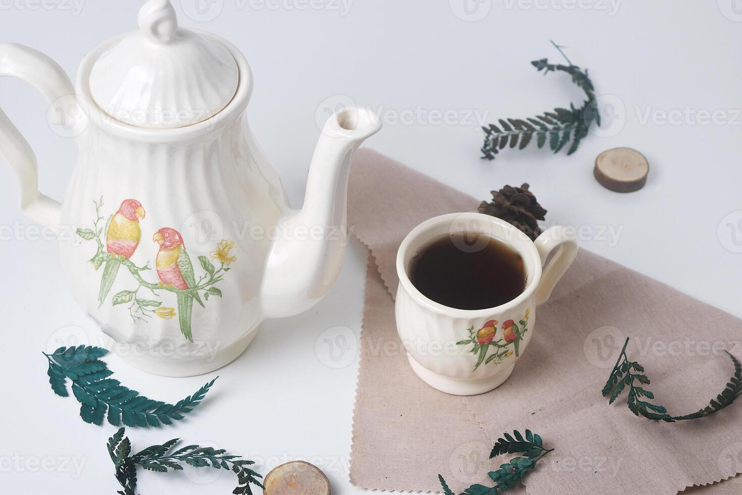 Sweet tea with a white cup and teapot with ceramic material photo