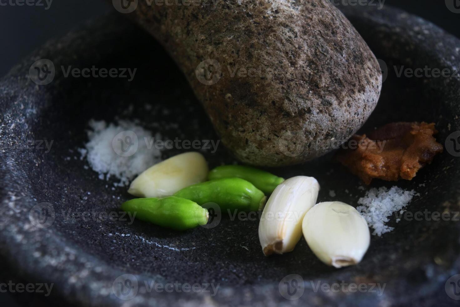 Close up of a stone blender is for making green chilli sauce photo