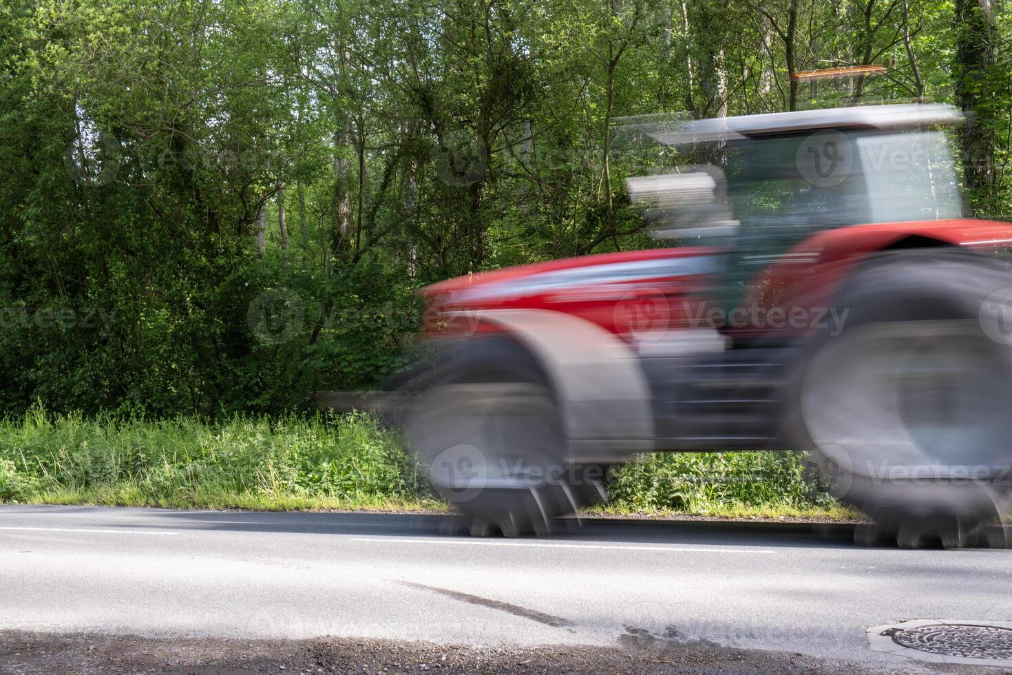 Motion blur of red fast tractor. photo