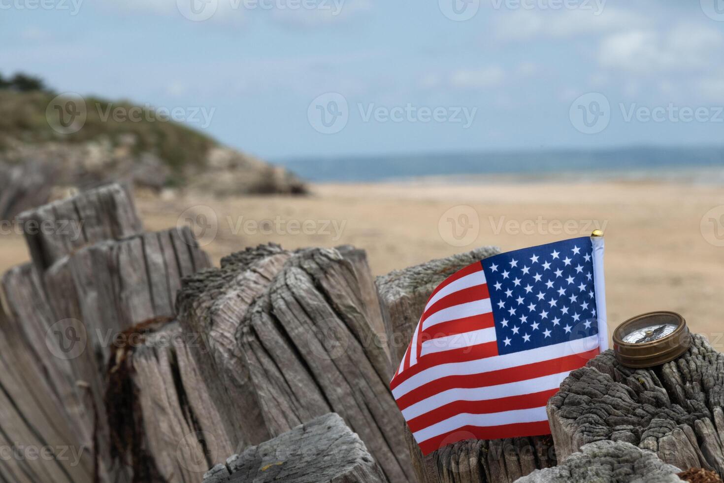Utah Beach Normandy with USA flag selective focus on beach and ocean. photo