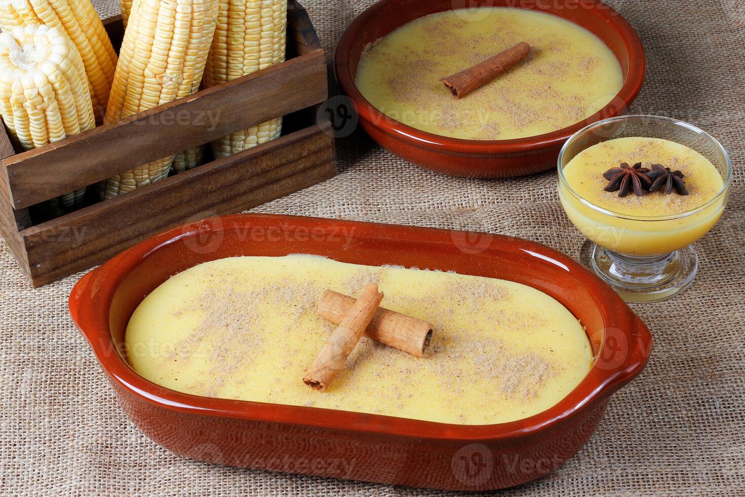 Curau, cream of corn sweet and dessert typical of the Brazilian cuisine, placed in ceramic bowl on wooden table. photo