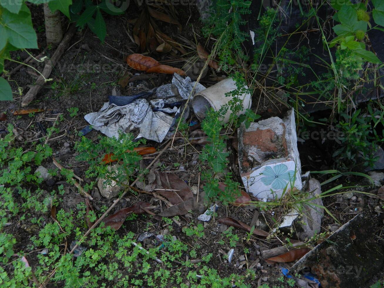 Waste that can damage the environment is often found in urban areas with poor waste management photo