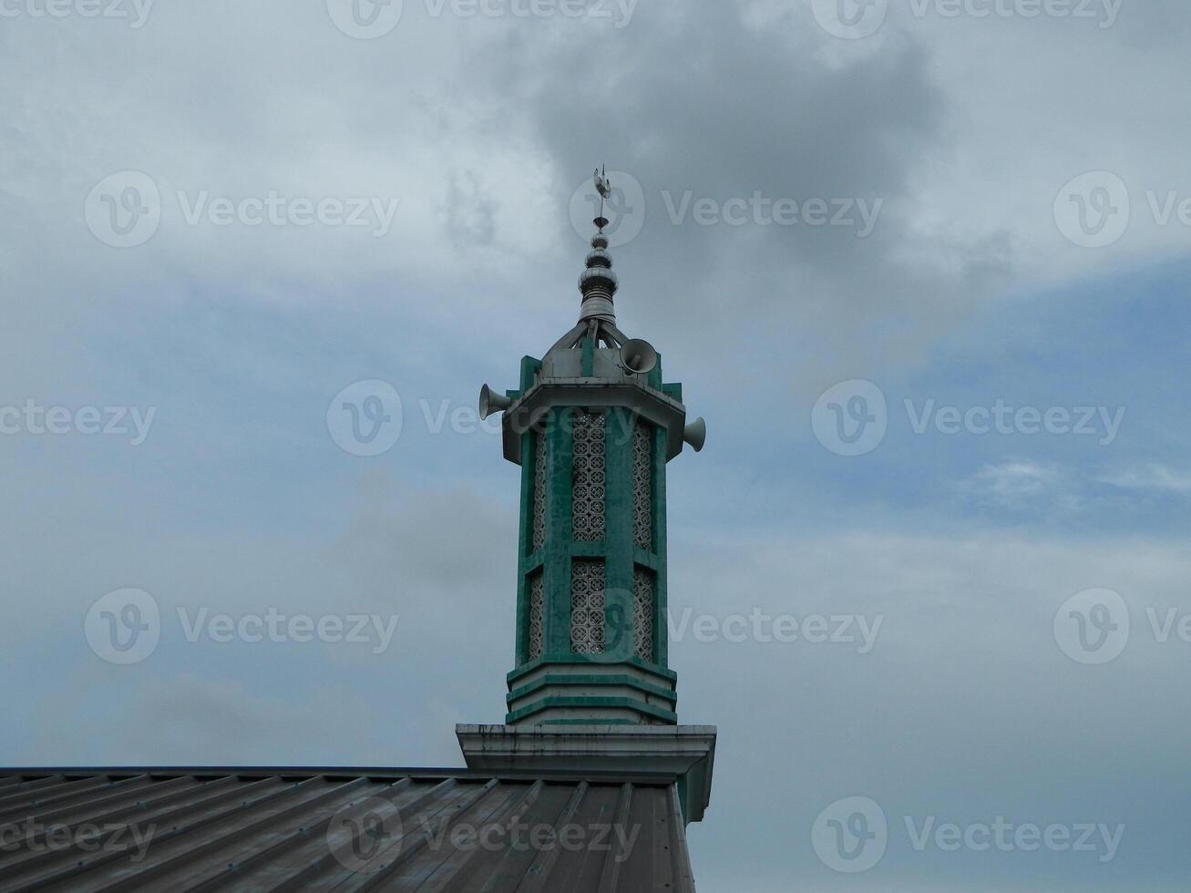Photo of the mosque tower taken from the top floor of a multi-storey building. The mosque tower is used as a marker and also as a loudspeaker