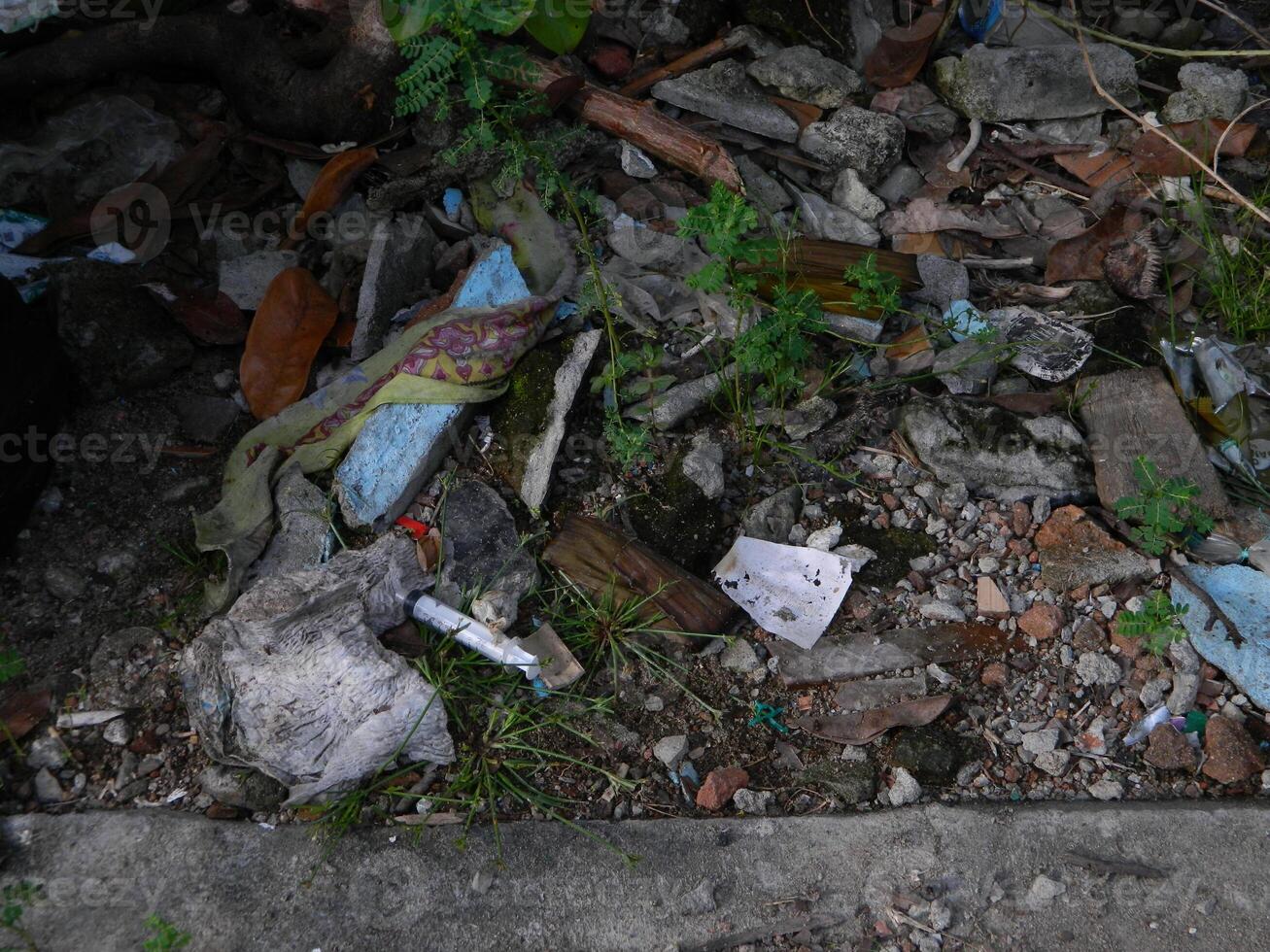 Waste that can damage the environment is often found in urban areas with poor waste management photo